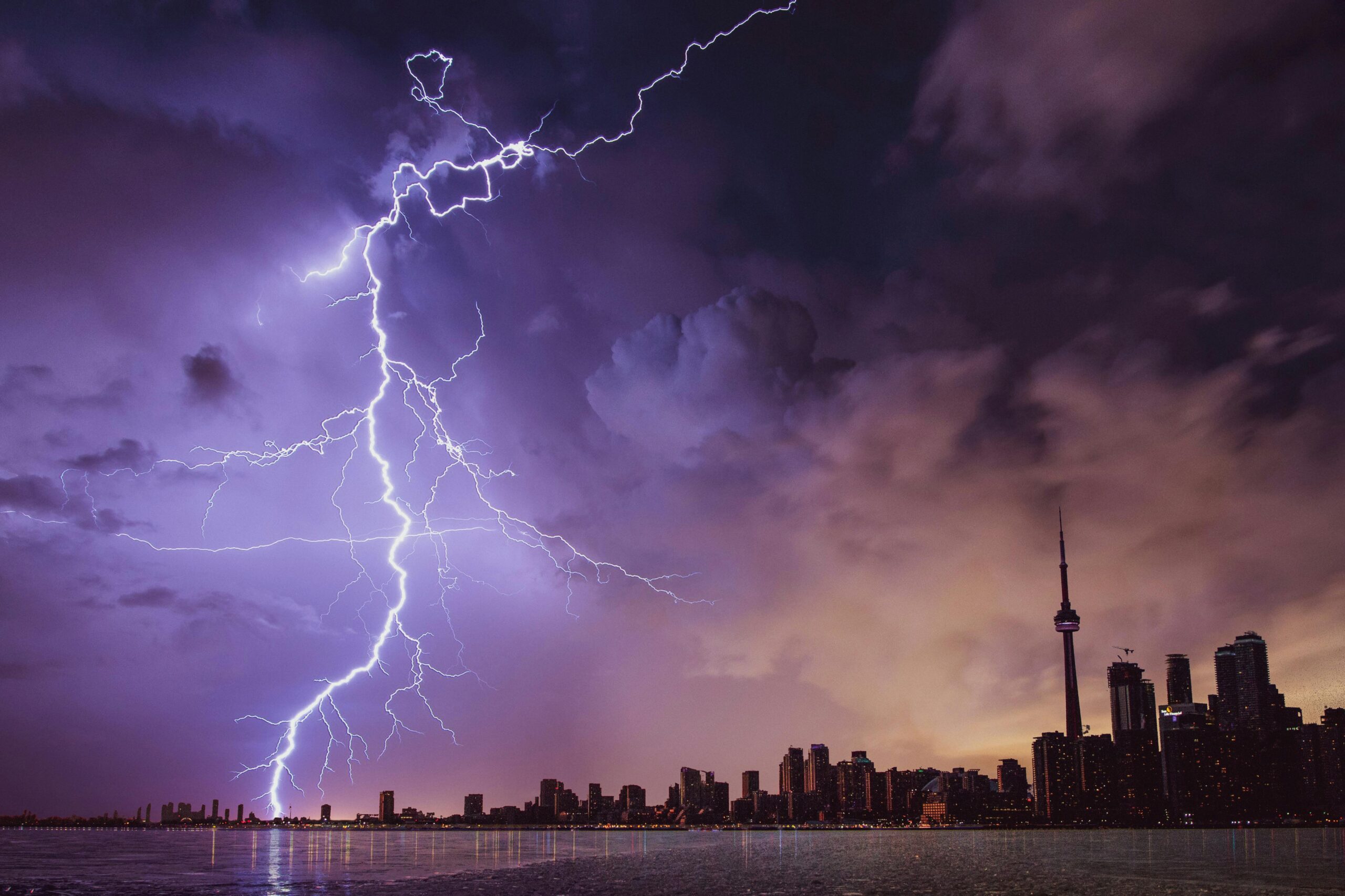 cta-02 A striking lightning bolt illuminates the Toronto skyline against a dramatic stormy sky.